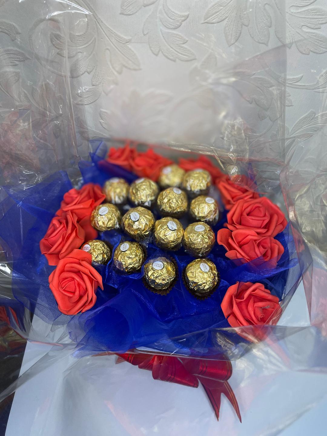 Ferrero Rocher Chocolates in a Bouquet with Blue Mesh and Red Roses ...